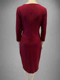 Red dress on a mannequin against a gray background