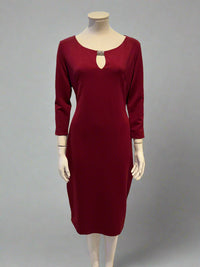 Mannequin wearing a burgundy dress with a white background