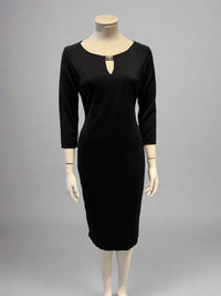 Black dress on a mannequin against a neutral background